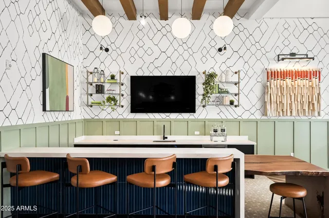 a kitchen with a sink and a stove with chairs