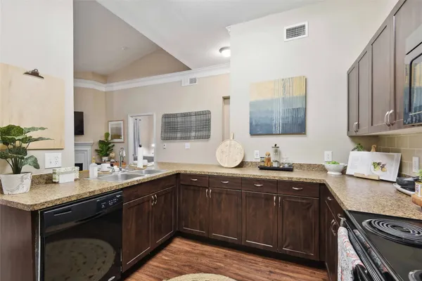 a kitchen with a sink stove and cabinets