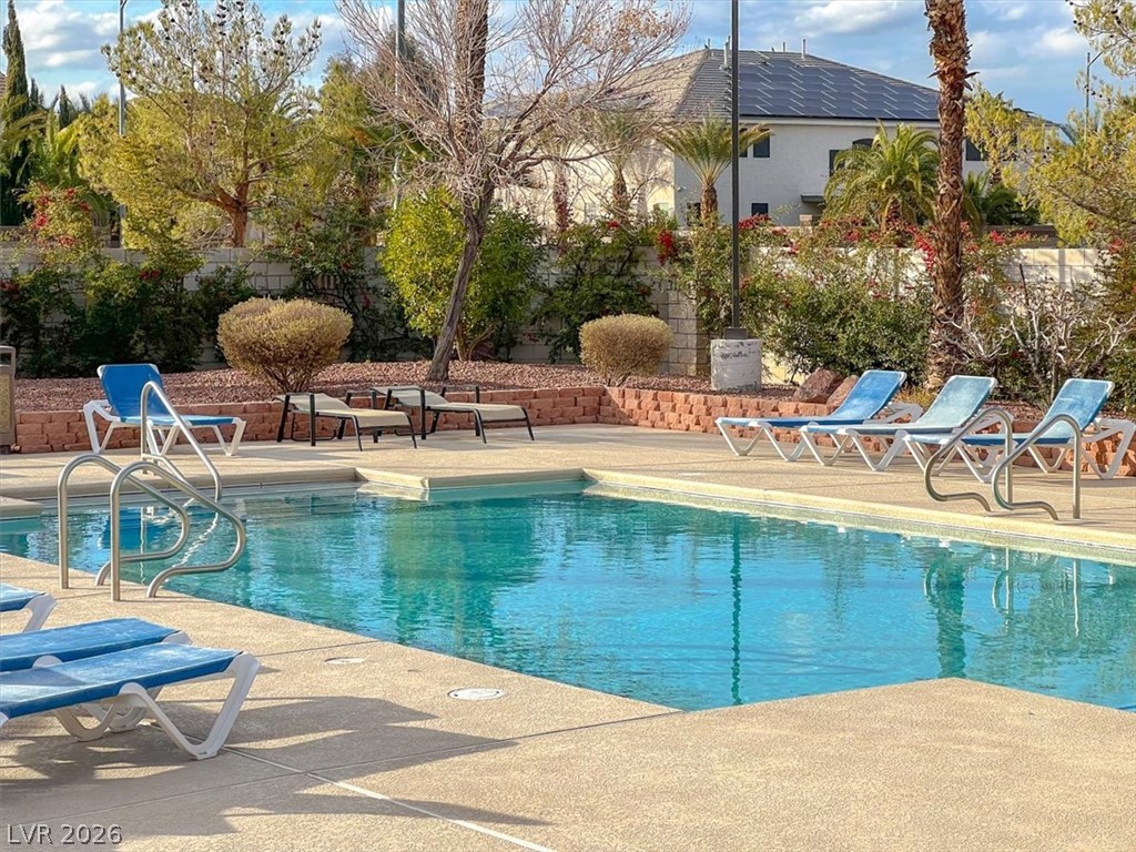 10148 Tree Bark Street Las Vegas, NV 89183 - Photo 36 of 37 An inviting private pool beckons for relaxation amidst lush, verdant landscaping.