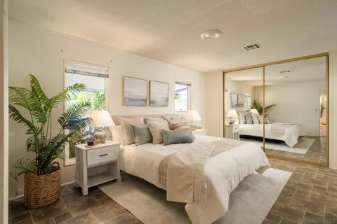 a bedroom with a bed and a couch