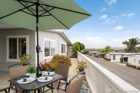 a view of a patio with table and chairs under an umbrella
