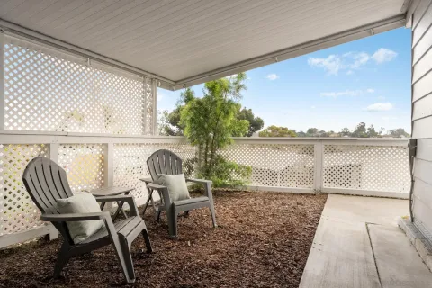 a view of a chairs and table in patio