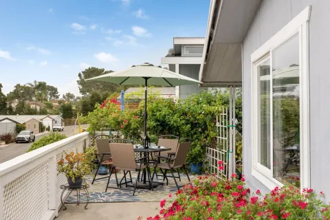 a view of a chairs and table in the balcony