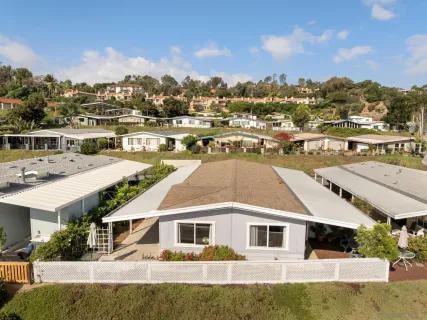 a view of a house with a swimming pool and a yard