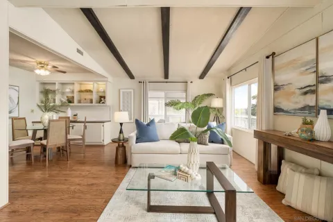 a living room with furniture wooden floor and a table