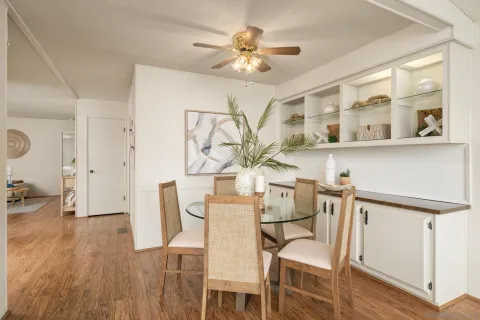 a view of a dining room with furniture and wooden floor