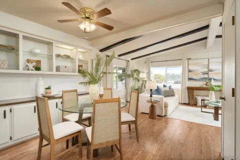 a view of a dining room with furniture wooden floor and chandelier