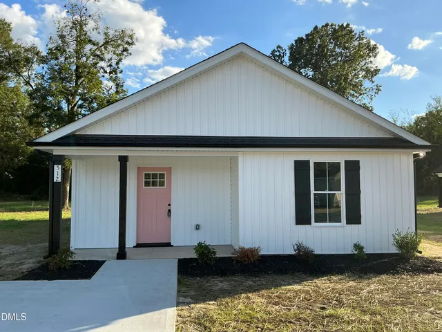 a house with trees in the background