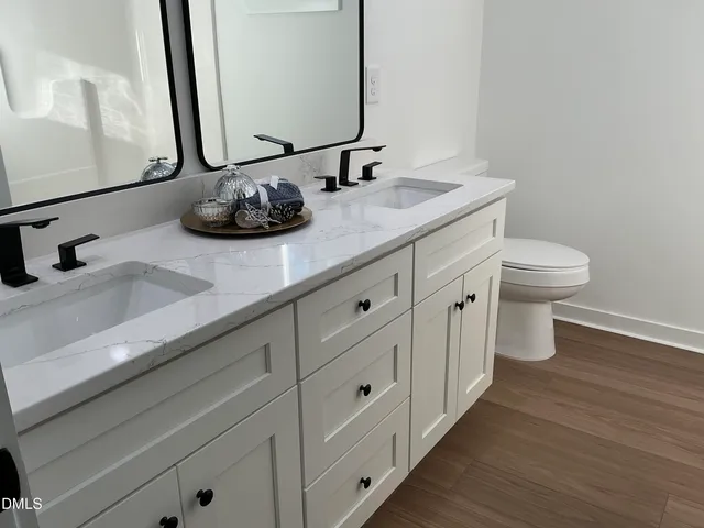a bathroom with a double vanity sink and a mirror