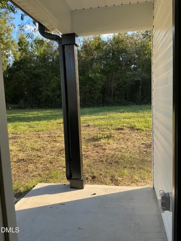 a view of a room with a large window and front door