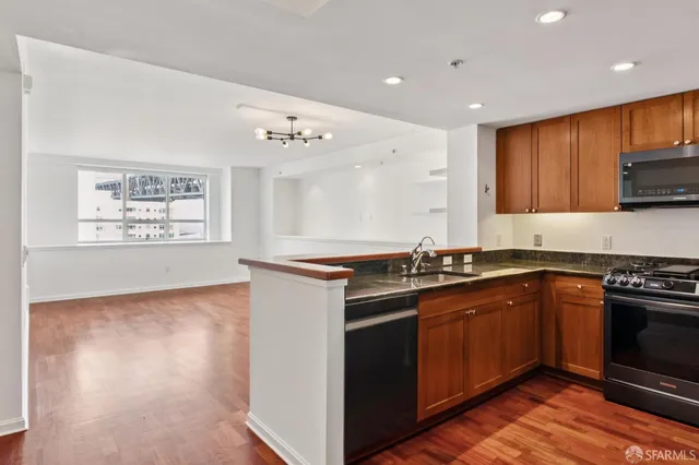 a kitchen with stainless steel appliances granite countertop a stove and a sink