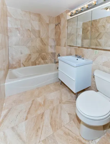 a bathroom with a sink a toilet and bathtub