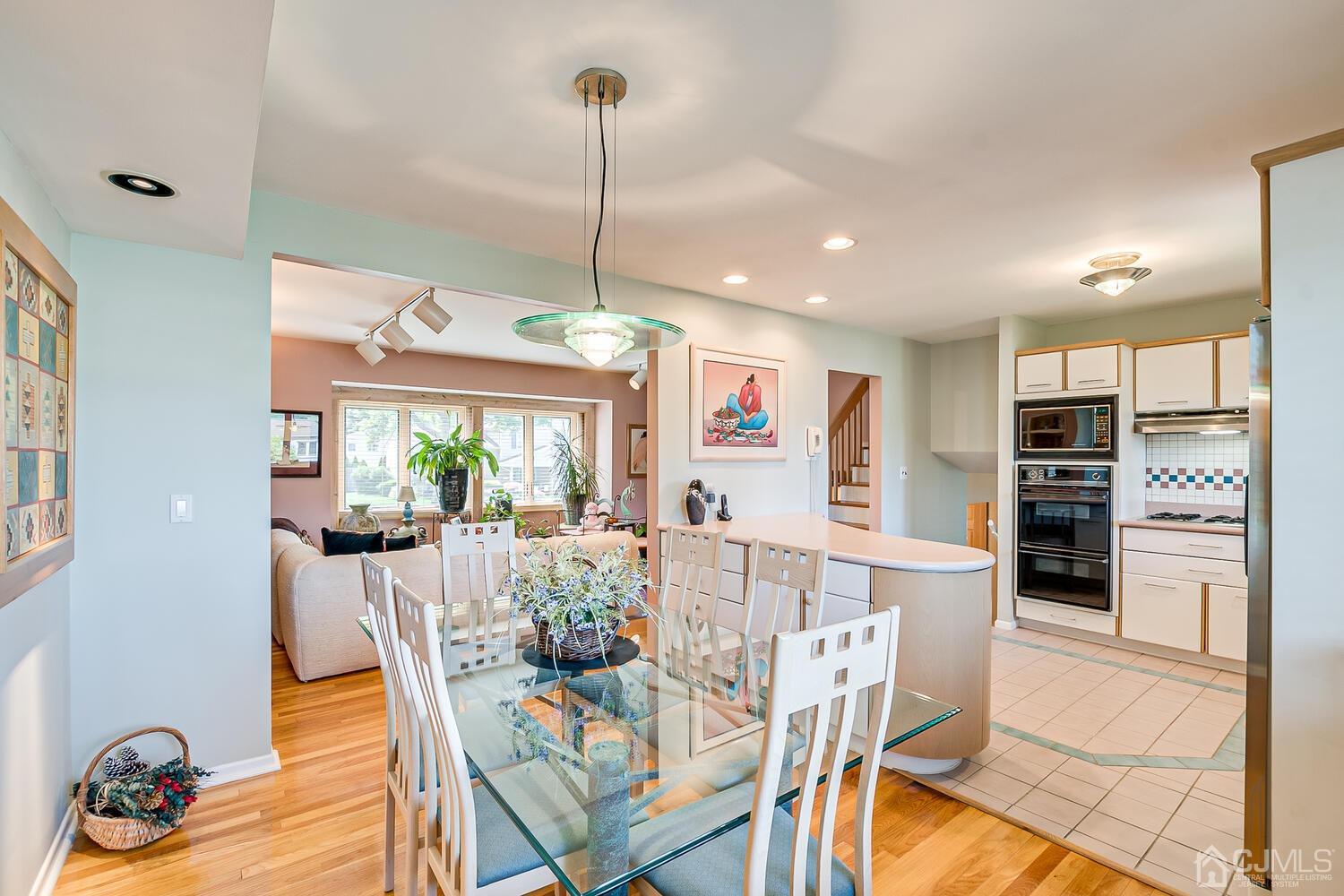 20 Rieder Road Edison, NJ 08817 - Photo 16 of 40 a view of a dining room and livingroom with furniture wooden floor a chandelier