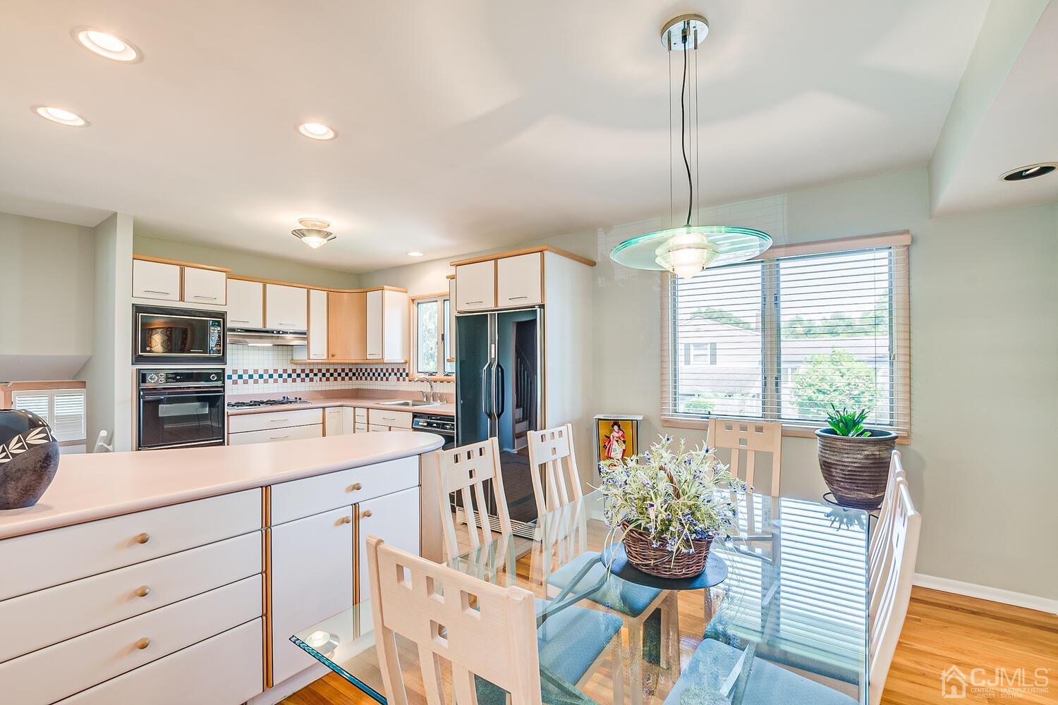20 Rieder Road Edison, NJ 08817 - Photo 17 of 40 a kitchen with stainless steel appliances kitchen island granite countertop a refrigerator a stove a sink dishwasher and a wooden cabinets
