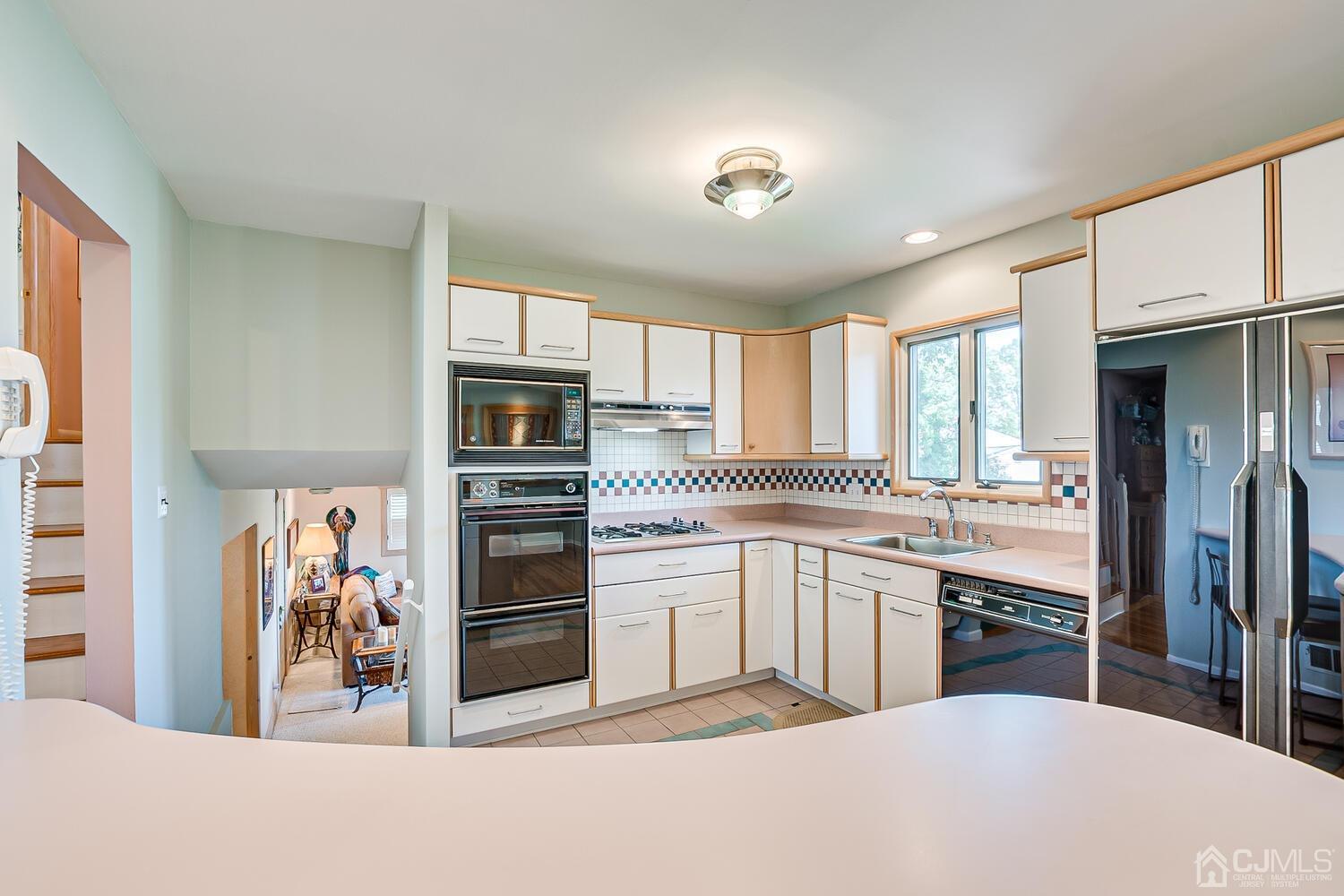 20 Rieder Road Edison, NJ 08817 - Photo 18 of 40 a kitchen with stainless steel appliances granite countertop a refrigerator and a stove top oven