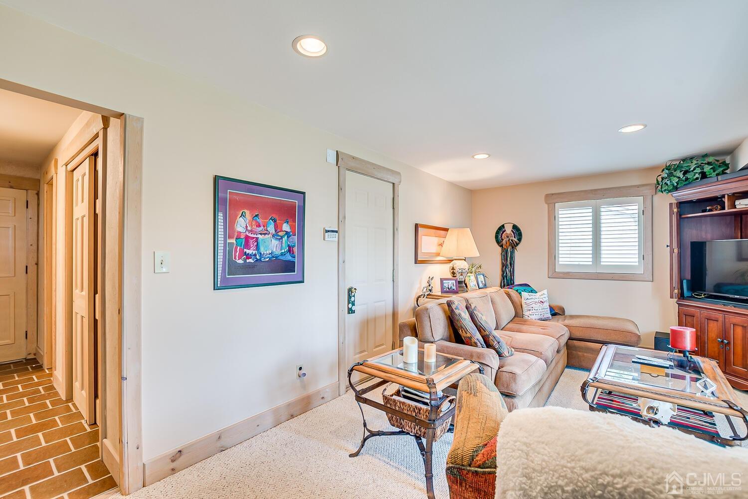 20 Rieder Road Edison, NJ 08817 - Photo 27 of 40 a living room with furniture a flat screen tv and a window