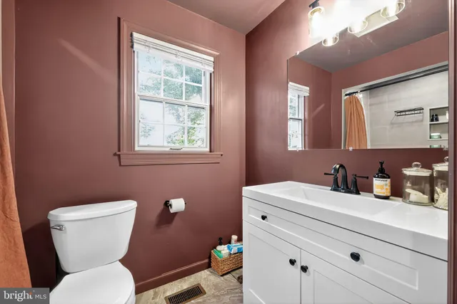 a backyard of a house with a yard and tree