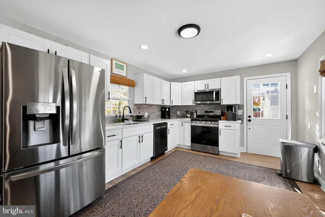 a kitchen with sink a microwave and stove
