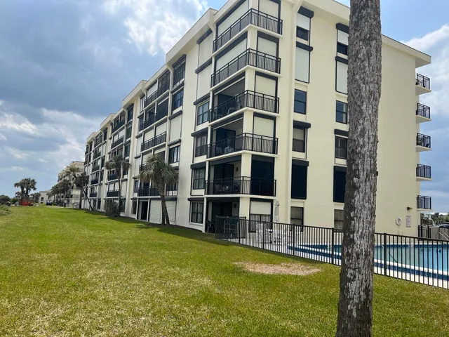 a view of building with swimming pool in front of it