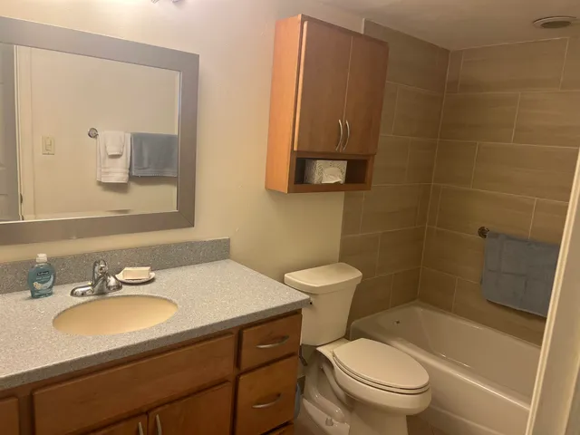 a bathroom with a sink toilet and shower