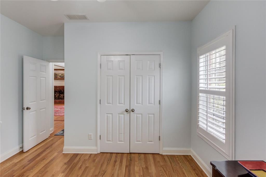 124 Dumar Lane Hoschton, GA 30548 - Photo 21 of 49 an empty room with wooden floor and windows