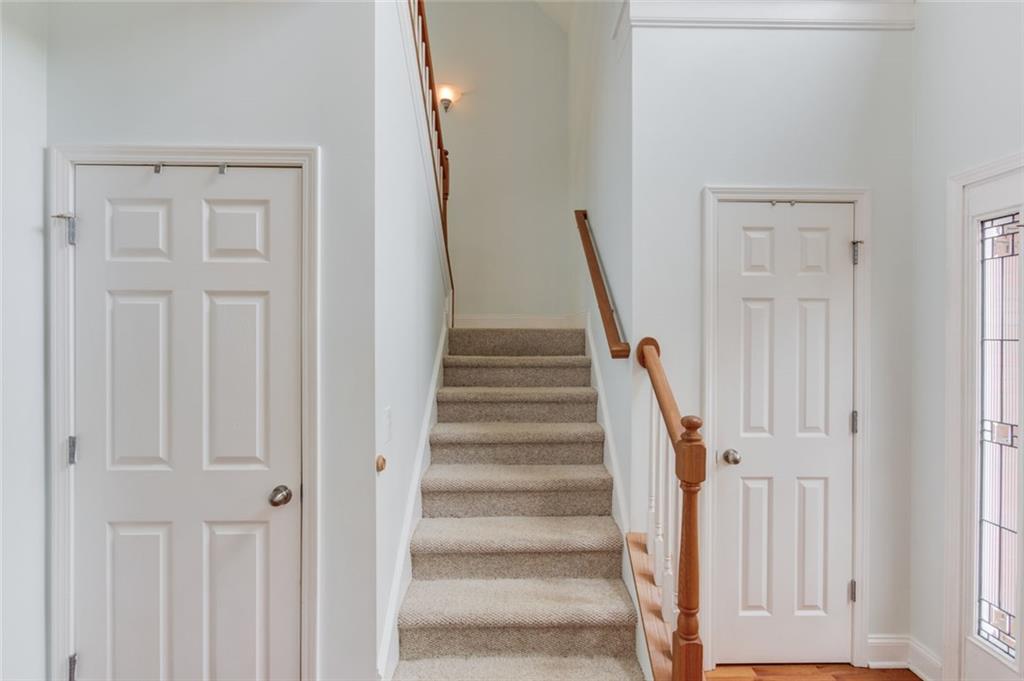 124 Dumar Lane Hoschton, GA 30548 - Photo 25 of 49 a view of staircase with white walls and white door