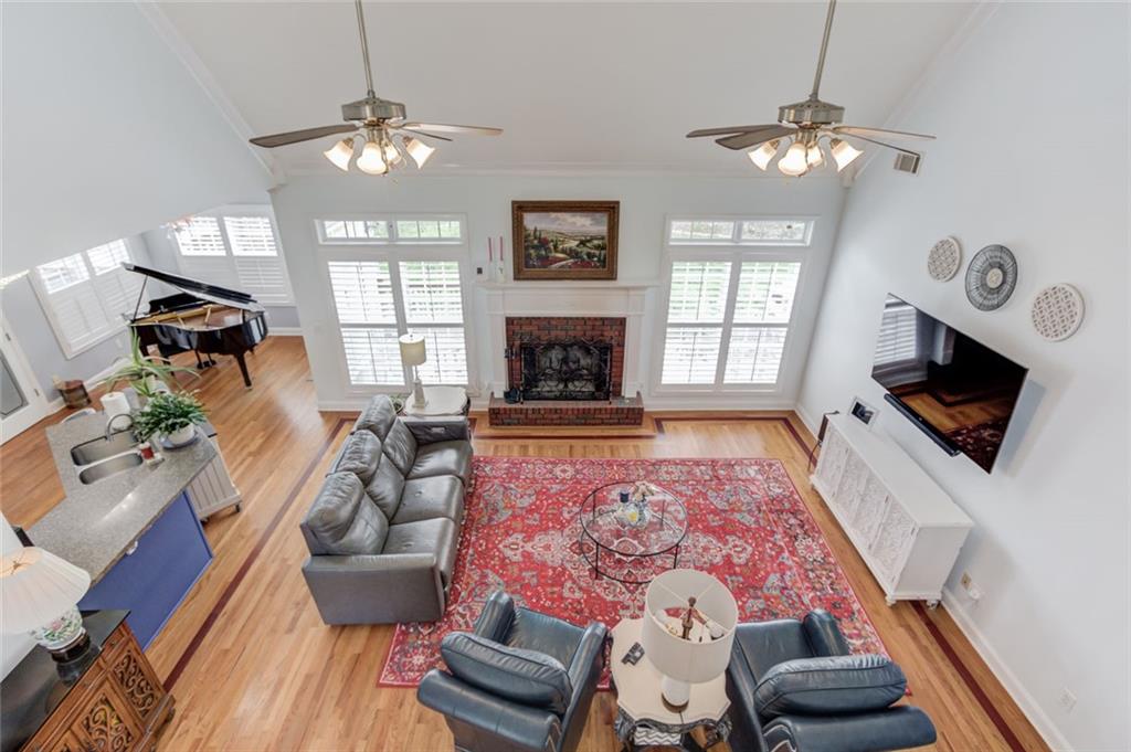 124 Dumar Lane Hoschton, GA 30548 - Photo 28 of 49 a living room with furniture a fireplace and a flat screen tv