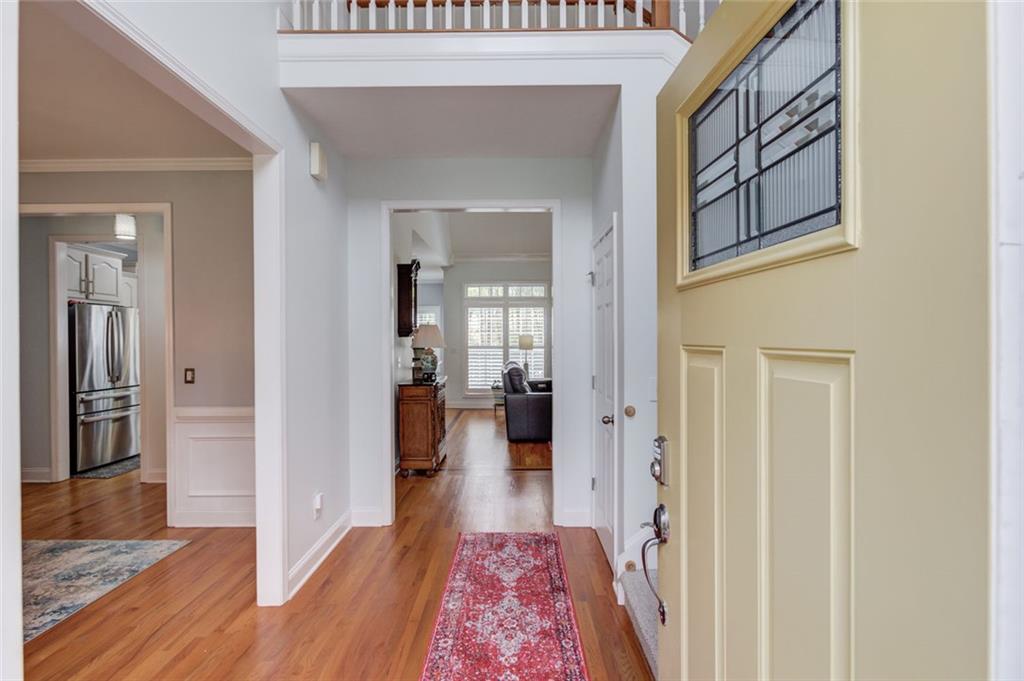124 Dumar Lane Hoschton, GA 30548 - Photo 3 of 49 a hallway with wooden floor fireplace and living room