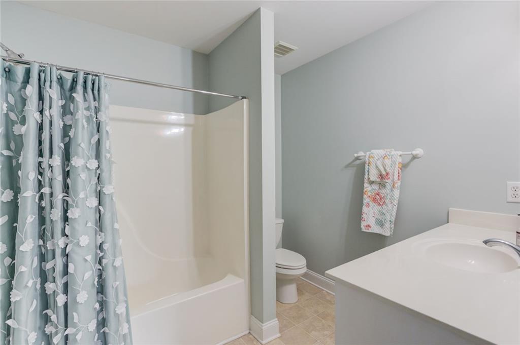 124 Dumar Lane Hoschton, GA 30548 - Photo 34 of 49 a bathroom with a shower curtain and a sink