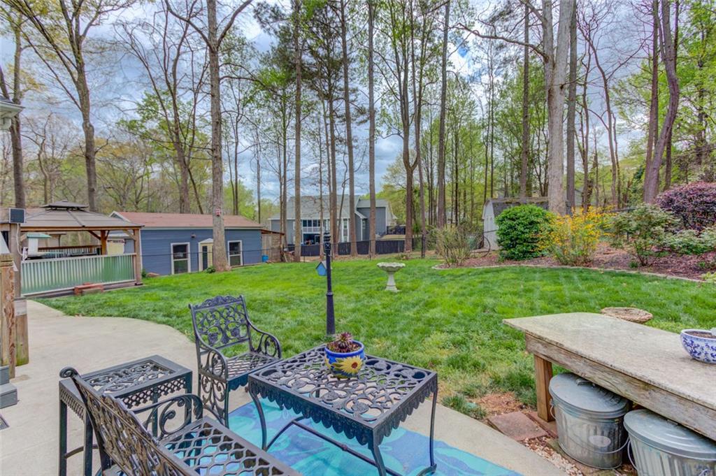124 Dumar Lane Hoschton, GA 30548 - Photo 37 of 49 a view of a backyard with sitting area furniture and garden