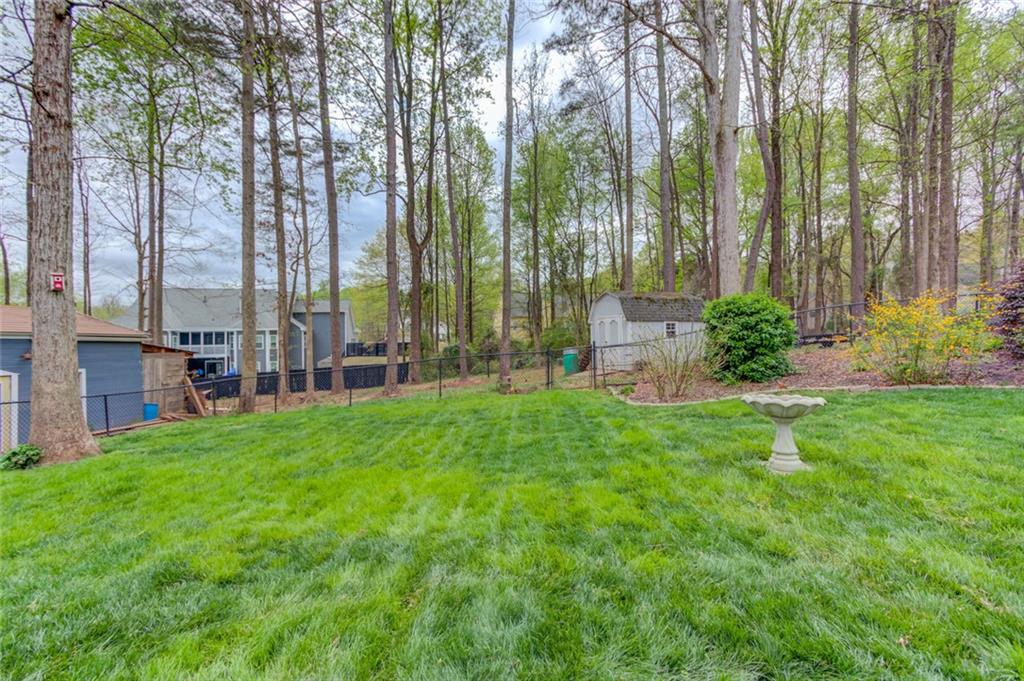 124 Dumar Lane Hoschton, GA 30548 - Photo 38 of 49 a garden with palm trees