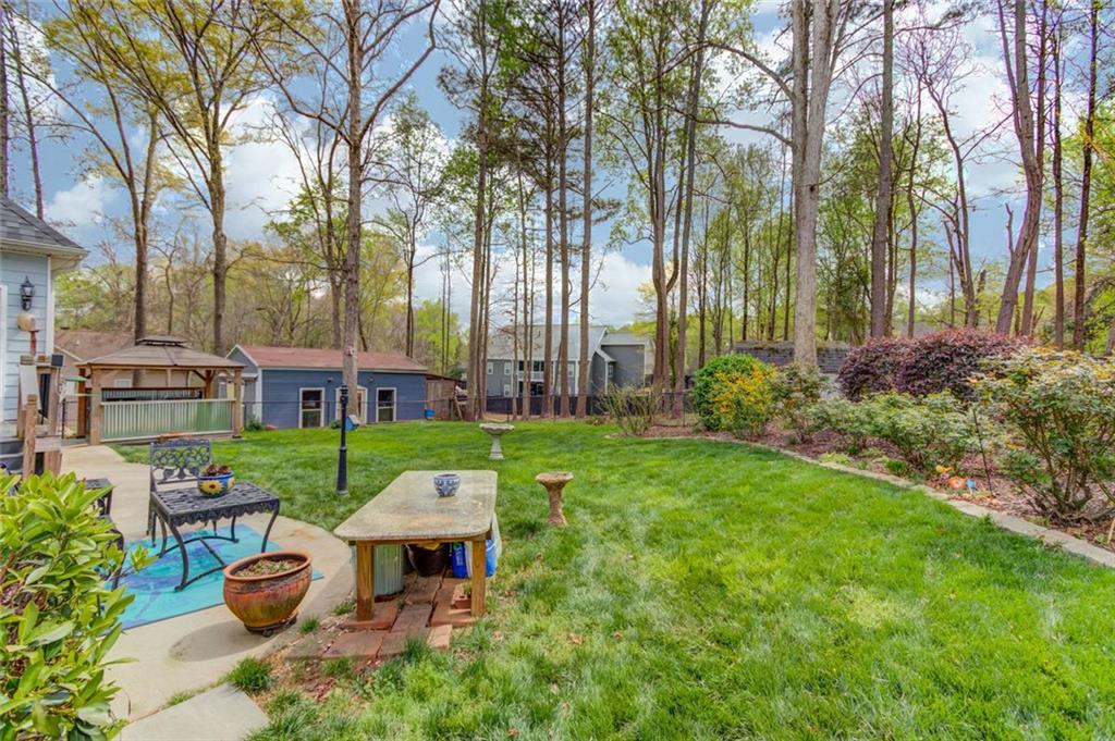 124 Dumar Lane Hoschton, GA 30548 - Photo 39 of 49 a front view of a house with garden and trees