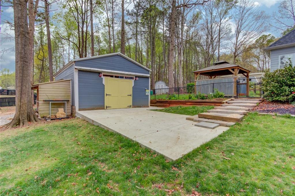 124 Dumar Lane Hoschton, GA 30548 - Photo 45 of 49 a front view of a house with a yard and trees