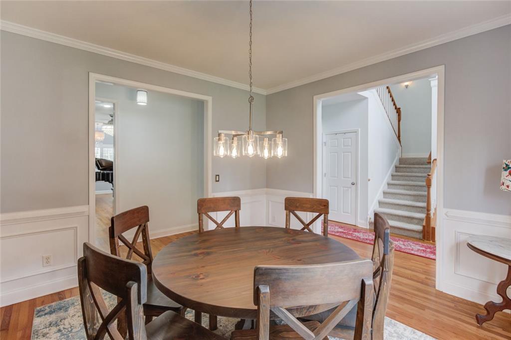 124 Dumar Lane Hoschton, GA 30548 - Photo 6 of 49 a view of a dining room with furniture and wooden floor