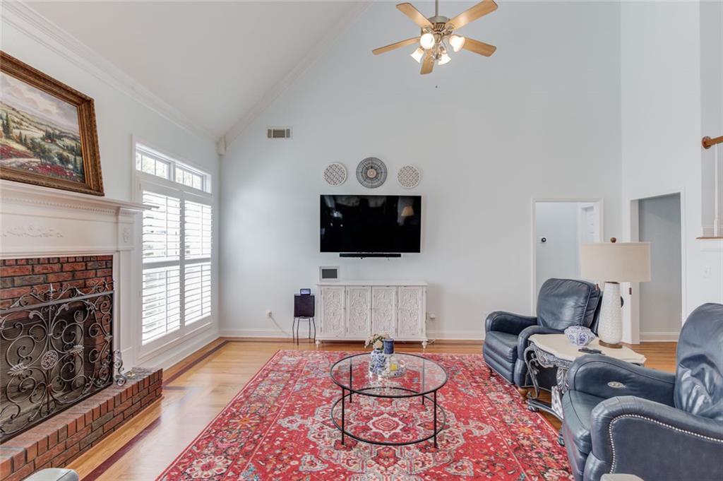 124 Dumar Lane Hoschton, GA 30548 - Photo 8 of 49 a living room with furniture a flat screen tv and a fireplace