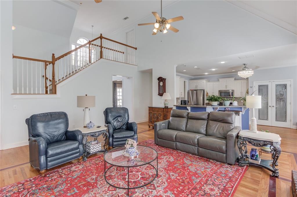 124 Dumar Lane Hoschton, GA 30548 - Photo 9 of 49 a living room with furniture a rug and a chandelier
