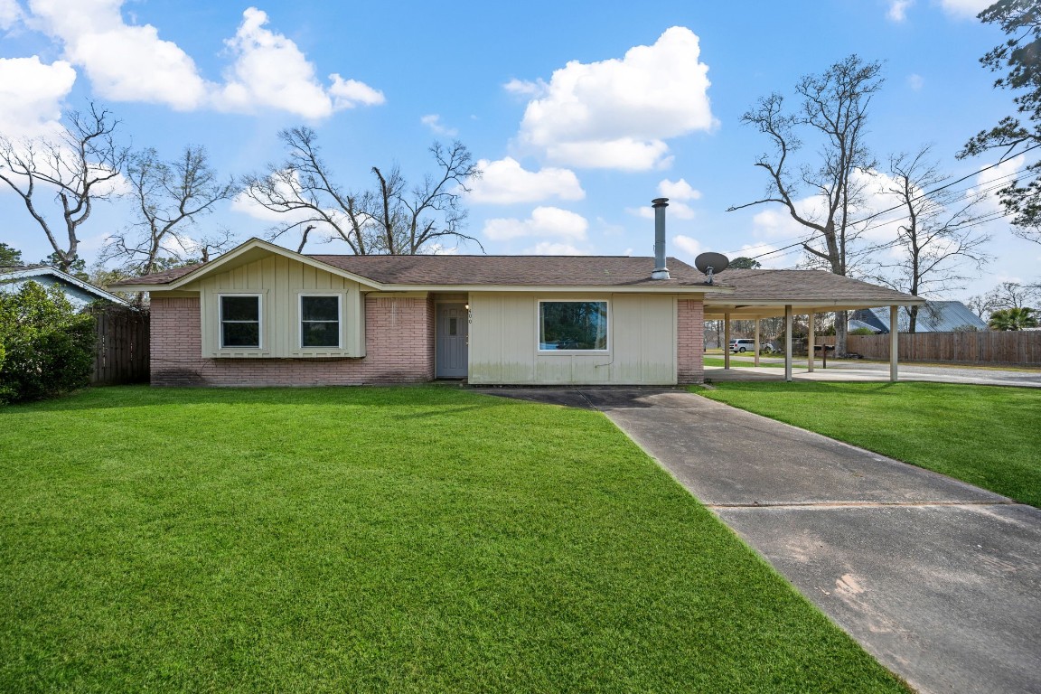 a front view of a house with a garden and yard