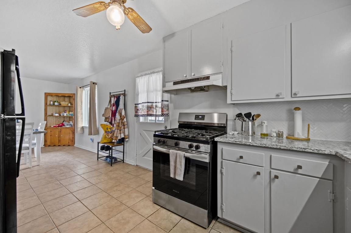 400 Dora Street Cleveland, TX 77328 - Photo 13 of 19 a kitchen with stainless steel appliances granite countertop a stove a sink and a refrigerator