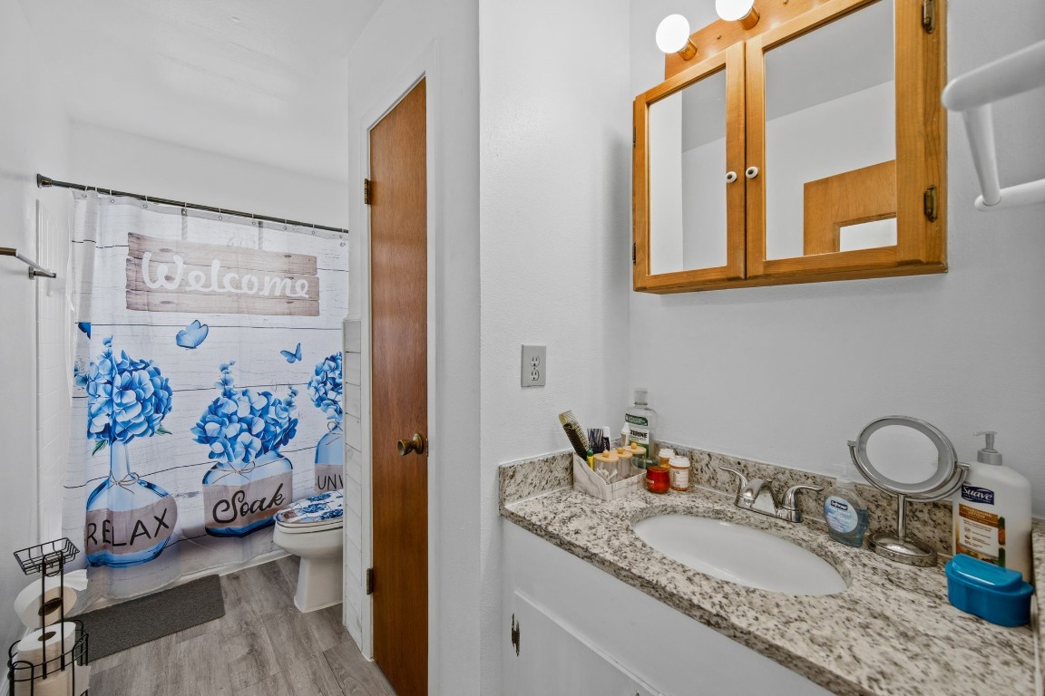 400 Dora Street Cleveland, TX 77328 - Photo 16 of 19 a bathroom with a granite countertop sink and a mirror