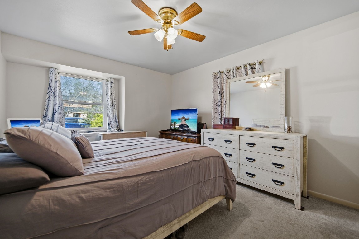 400 Dora Street Cleveland, TX 77328 - Photo 19 of 19 a bedroom with a bed and a chandelier