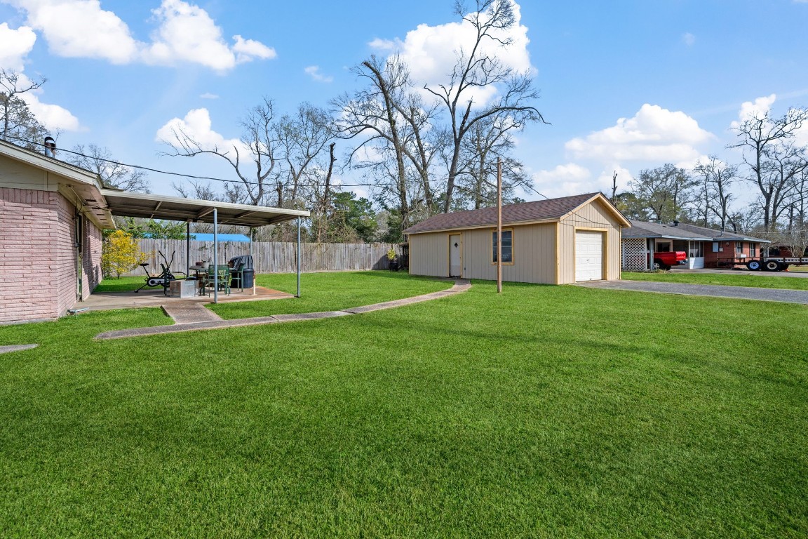 400 Dora Street Cleveland, TX 77328 - Photo 2 of 19 a view of a house with a big yard and potted plants