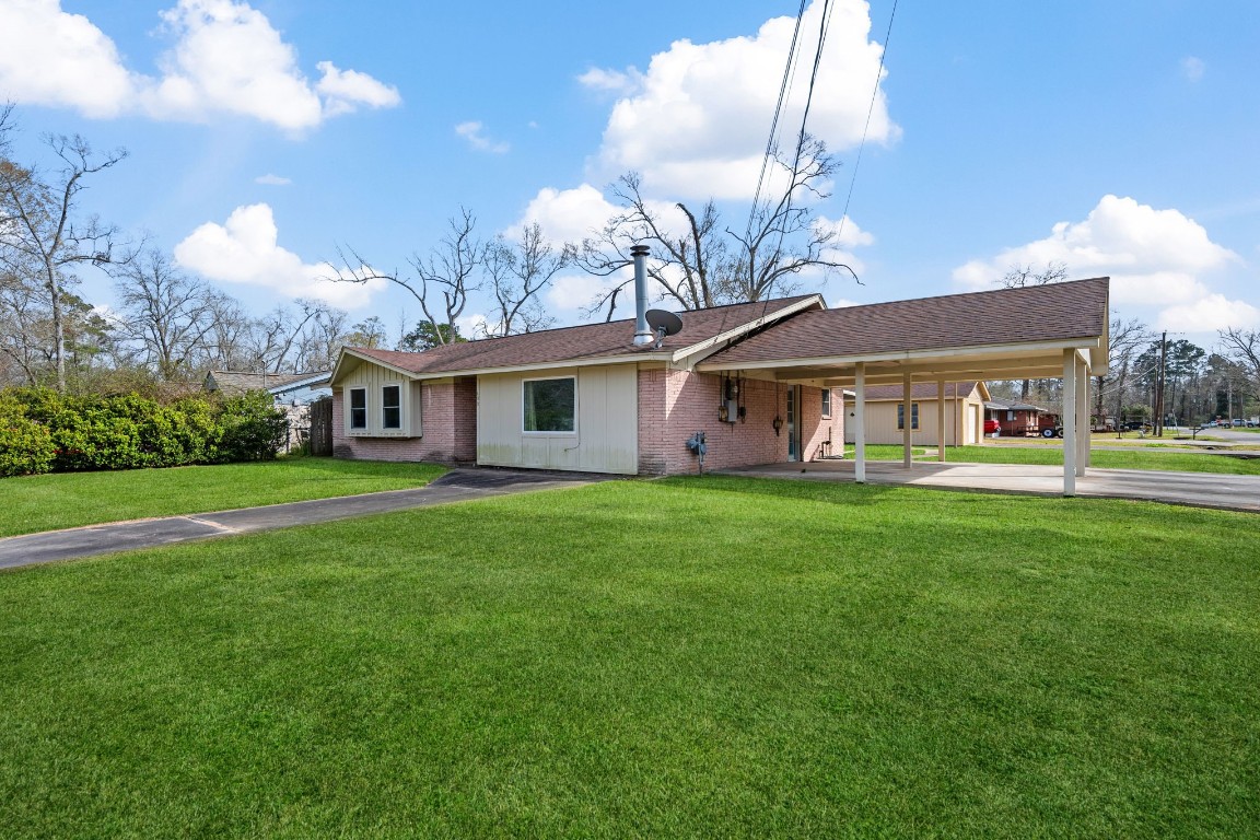 400 Dora Street Cleveland, TX 77328 - Photo 3 of 19 a front view of a house with a yard