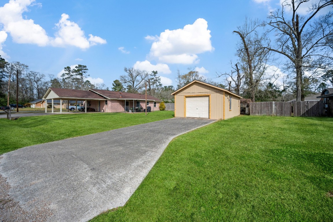 400 Dora Street Cleveland, TX 77328 - Photo 4 of 19 a view of a house with a yard