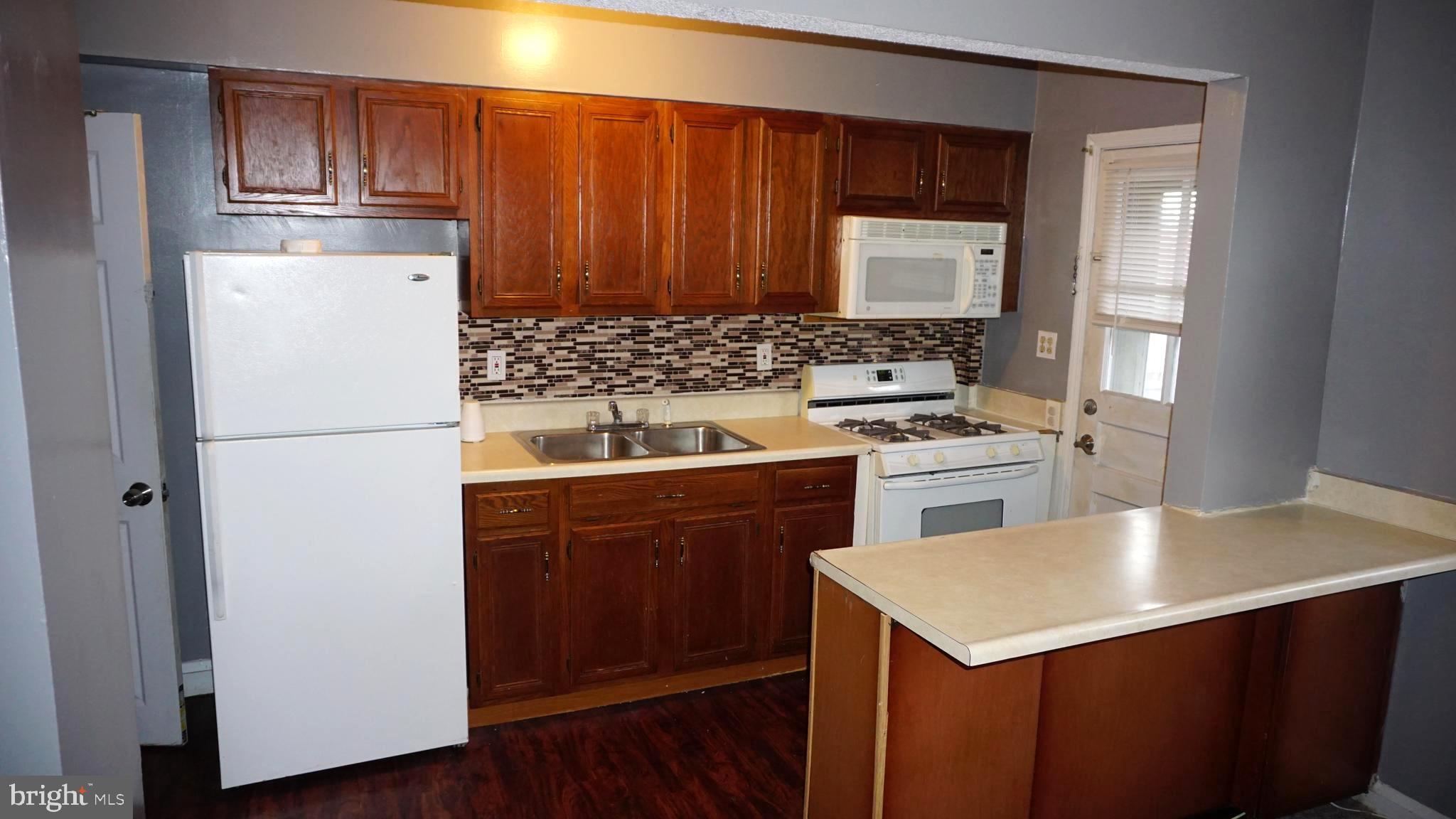 3436 Dunran Road Dundalk, MD 21222 - Photo 2 of 25 a kitchen with a sink a stove a refrigerator and cabinets