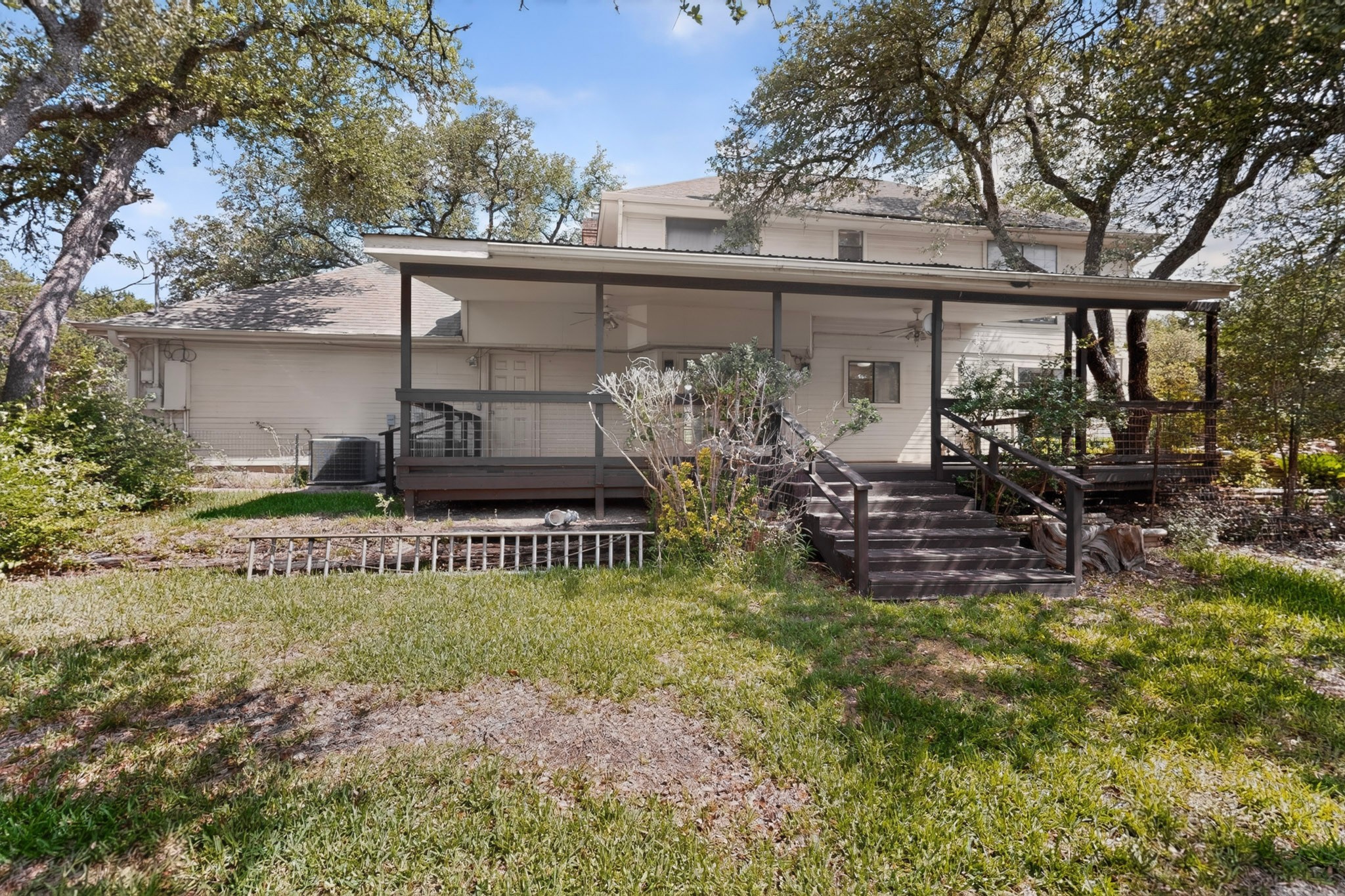 1003 Pier Branch Road Dripping Springs, TX 78620 - Photo 33 of 40 A spacious rear deck with covered patio offers a natural extension for outdoor living and entertaining.