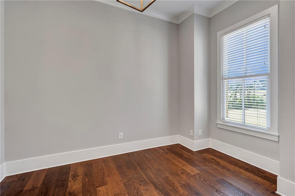 254 Fortress Way Jefferson, GA 30549 - Photo 15 of 69 a view of an empty room with wooden floor and a window