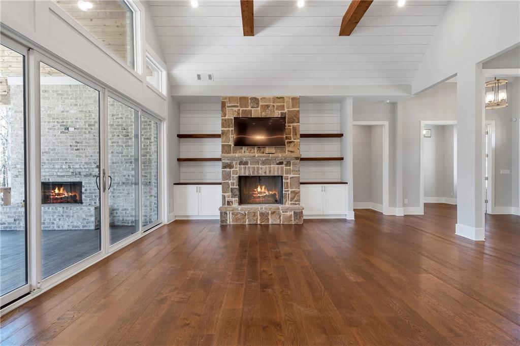 254 Fortress Way Jefferson, GA 30549 - Photo 19 of 69 a living room with stainless steel appliances furniture a fireplace and wooden floor