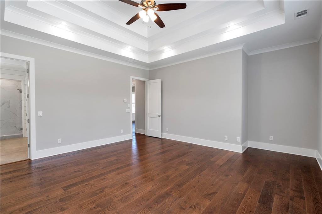 254 Fortress Way Jefferson, GA 30549 - Photo 29 of 69 an empty room with wooden floor and windows