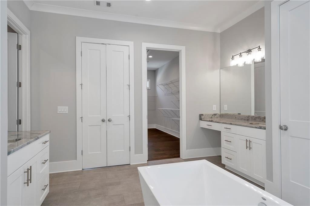 254 Fortress Way Jefferson, GA 30549 - Photo 33 of 69 a spacious bathroom with a double vanity sink and a mirror