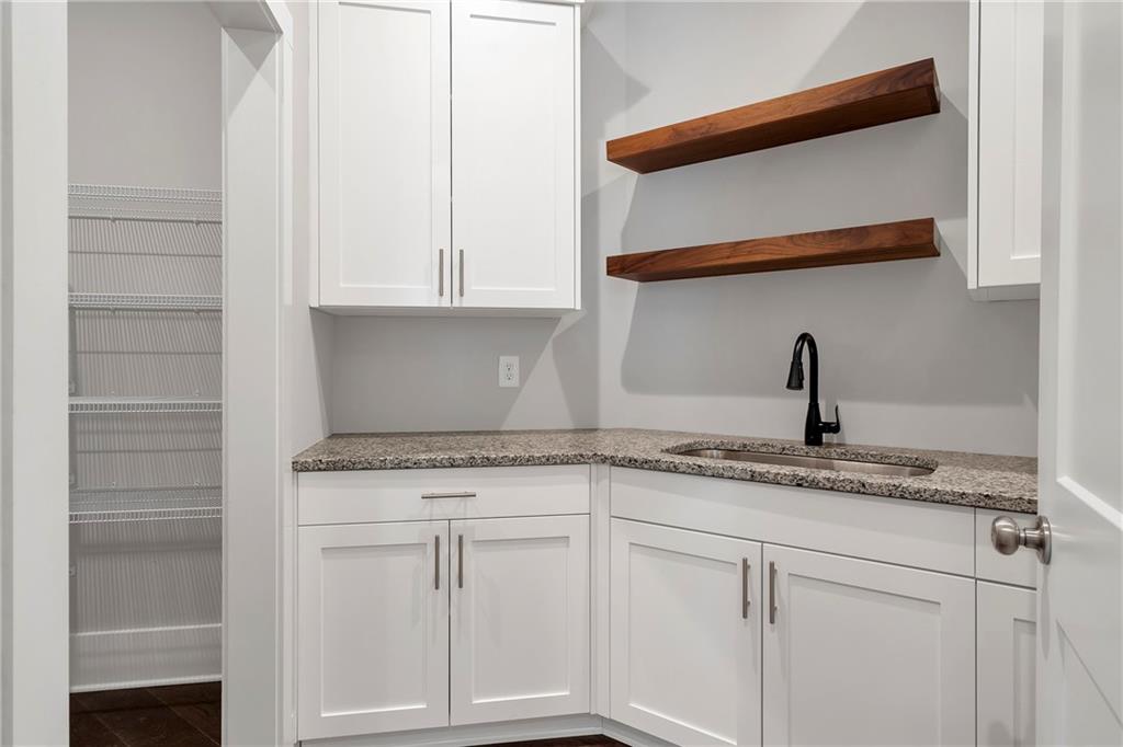 254 Fortress Way Jefferson, GA 30549 - Photo 37 of 69 a kitchen with white cabinets and a sink